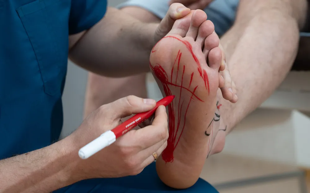 doctor examining patient for foot pain